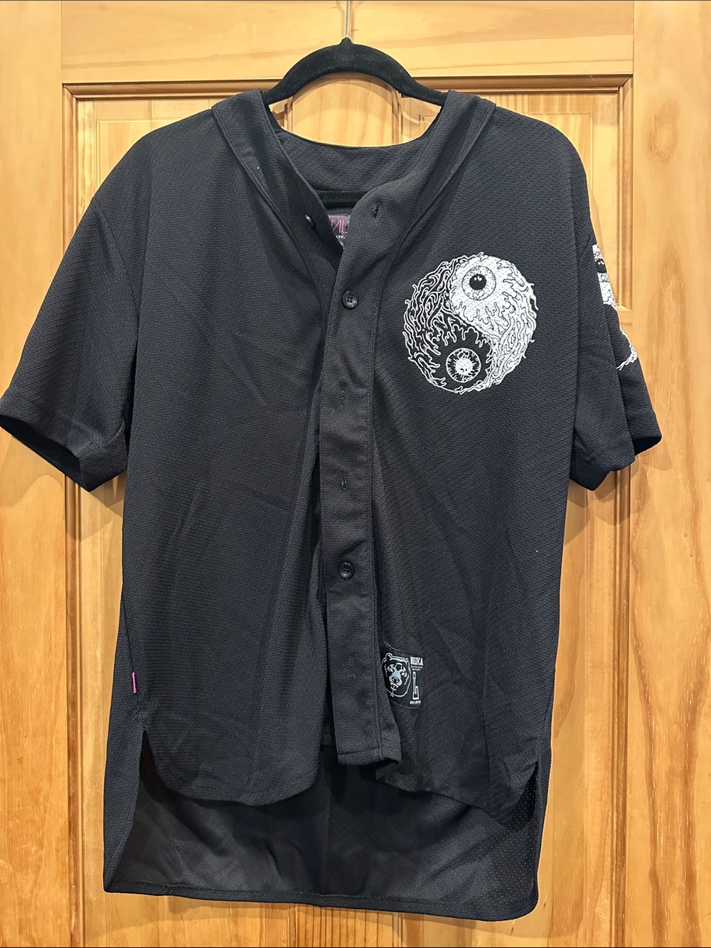 Mishka Black Short-Sleeve Baseball Jersey with Yin Yang Eye Graphic